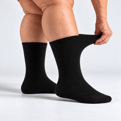 Stretching the soft top of a black SOKLA Original sock on fuller legs